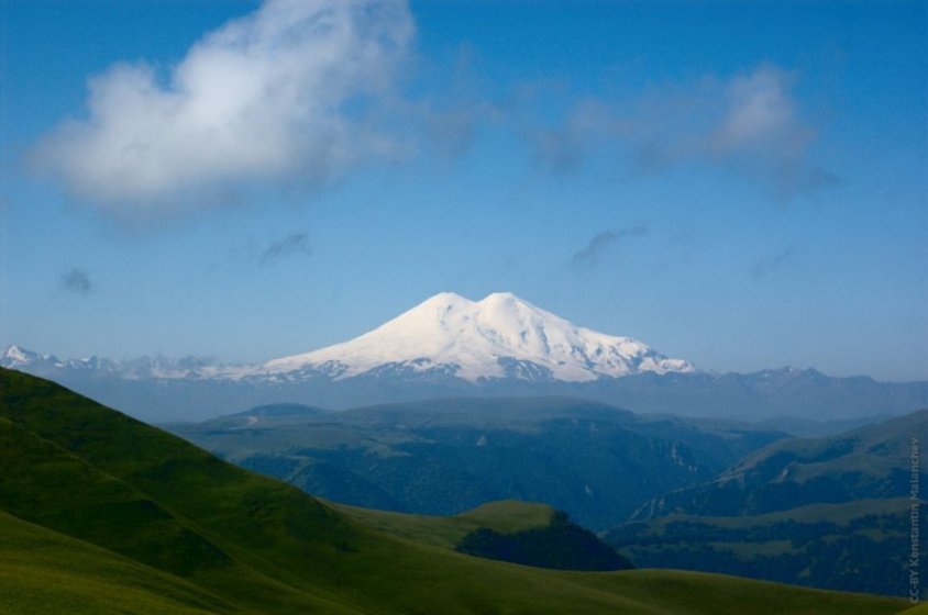 It has a shape of a saddle. Every year Elbrus takes lives of 15-20 climbers.